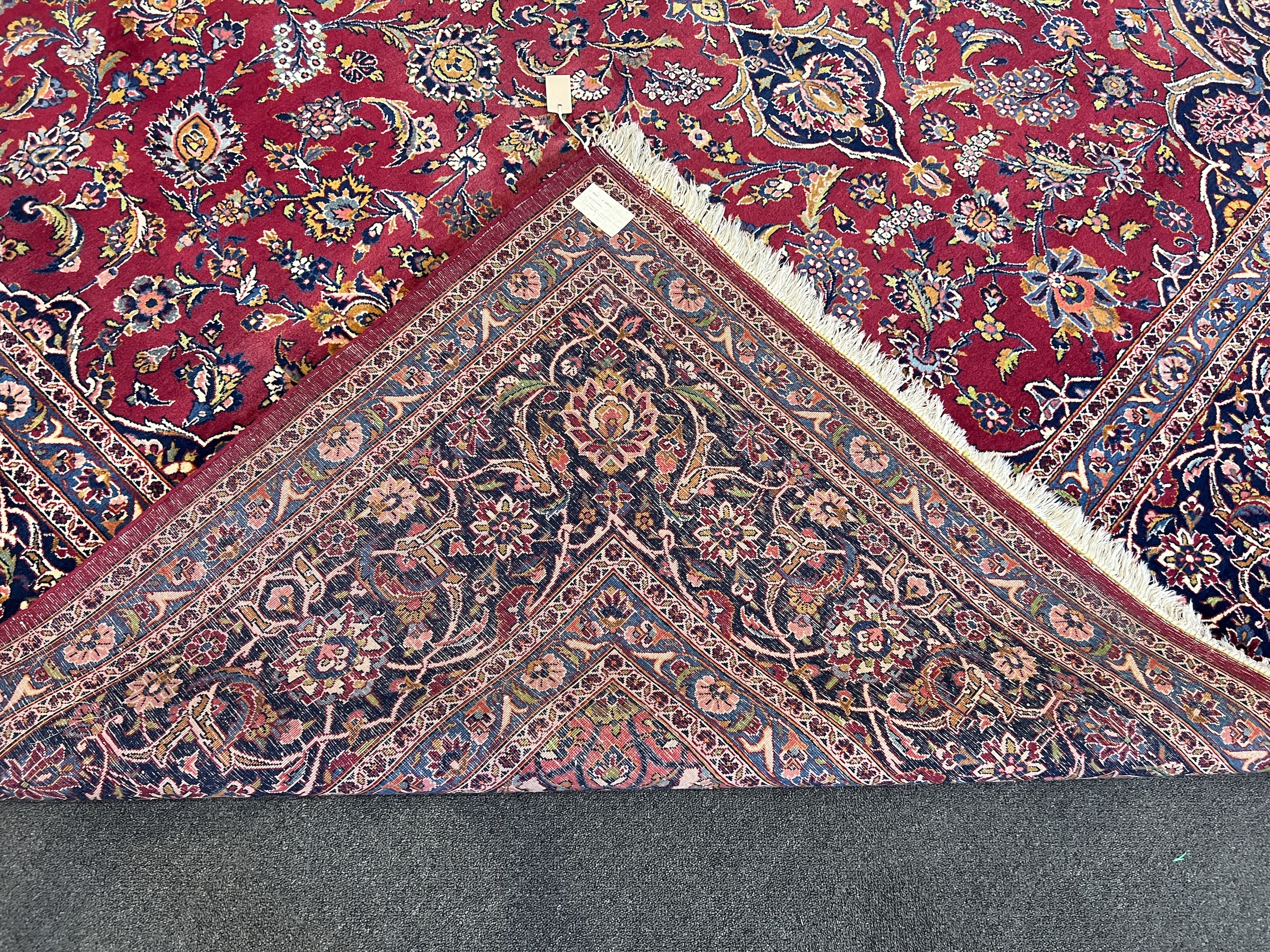 A Kashan burgundy ground carpet